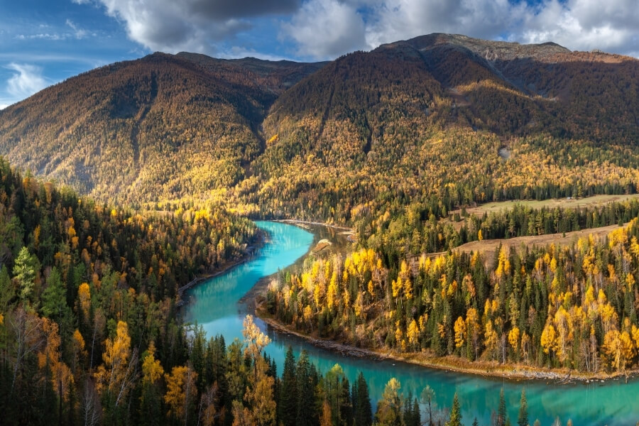 Xinjiang Silk Road desert oasis with Populus euphratica forests and mountains, popular tourist destination Xinjiang Silk Road desert oasis with Populus euphratica forests and mountains, popular tourist destination