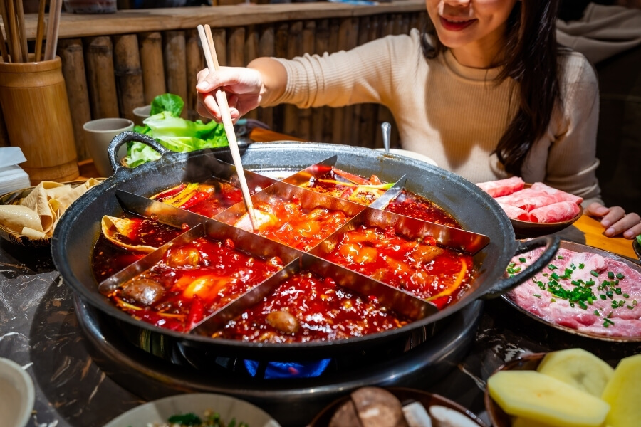 Chengdu hot pot with spicy broth, meat, vegetables, and tofu, Chinese shared dining experience for travelers