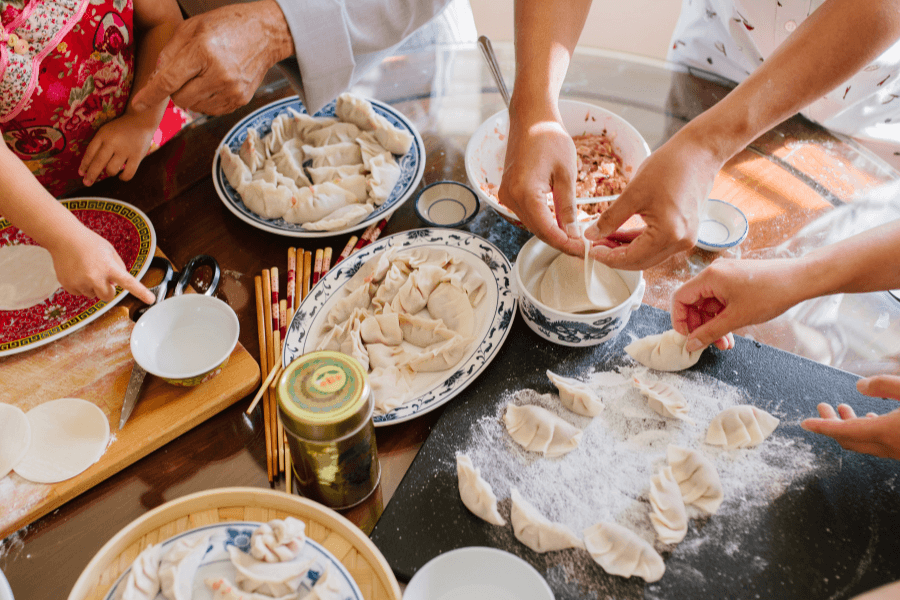 Chinese family making dumplings during Lunar New Year reunion dinner